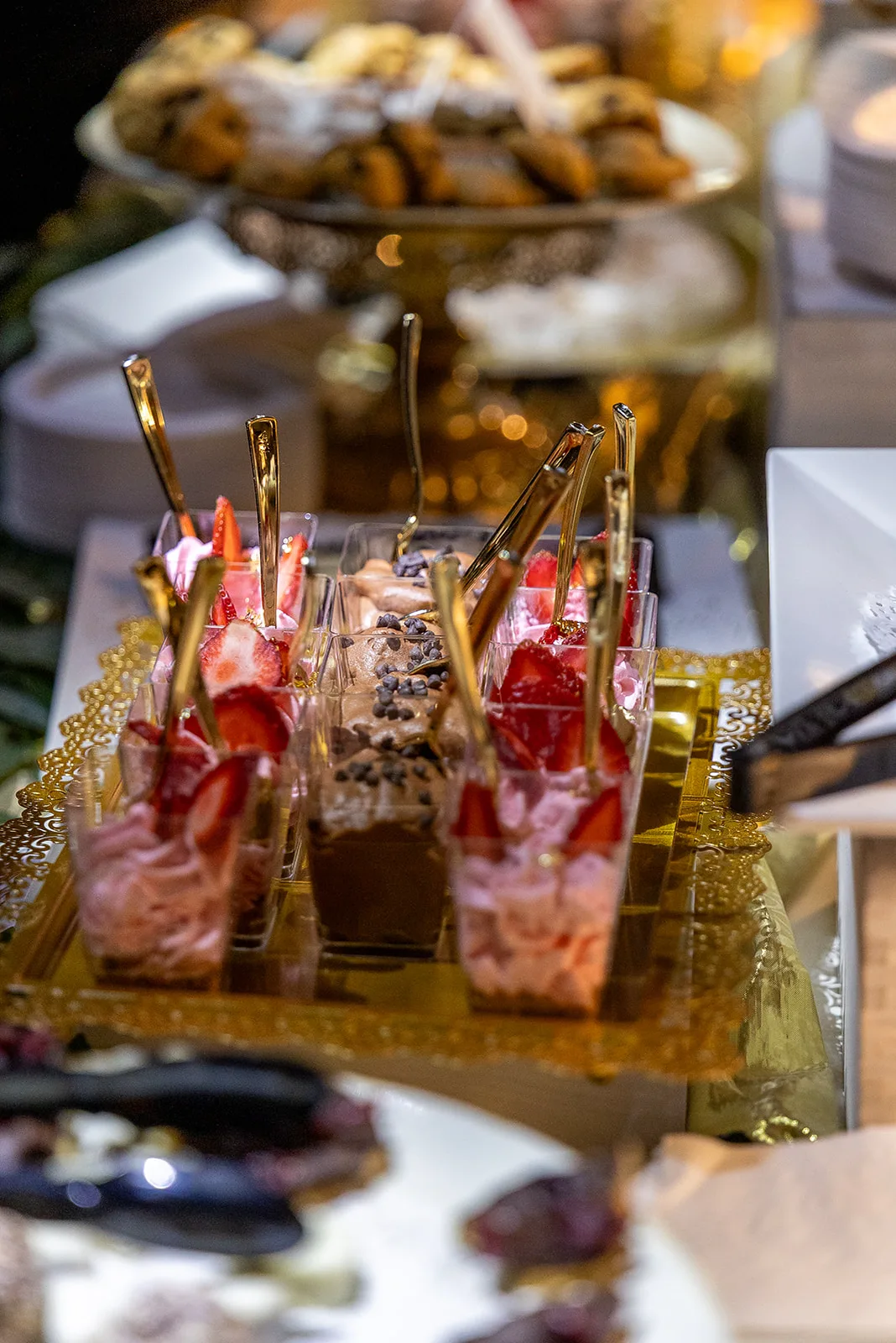 Layered dessert cups with gold spoons